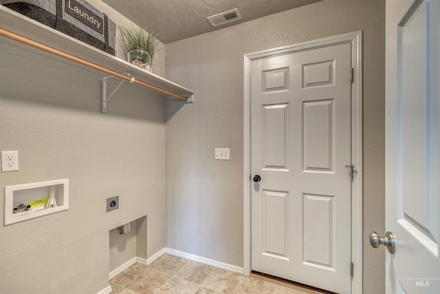 laundry area with laundry area, hookup for a washing machine, electric dryer hookup, baseboards, and visible vents