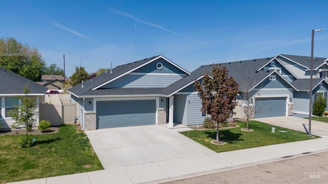 view of front facade featuring board and batten siding, driveway, a front yard, and a garage