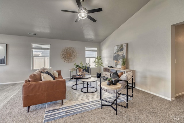 carpeted living room featuring visible vents, baseboards, ceiling fan, and lofted ceiling