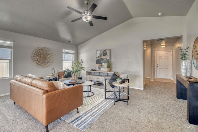 living room featuring carpet floors, ceiling fan, baseboards, and lofted ceiling