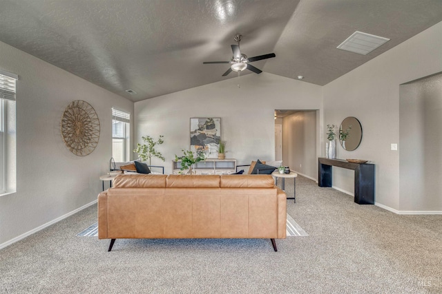 living room featuring ceiling fan, vaulted ceiling, light carpet, and baseboards