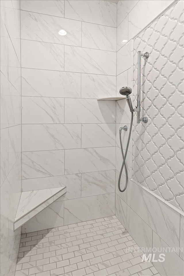 full bath with a tile shower