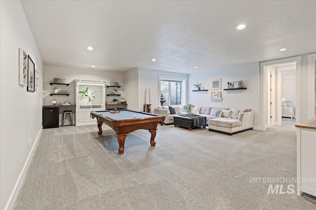 recreation room featuring carpet, baseboards, a textured ceiling, and recessed lighting