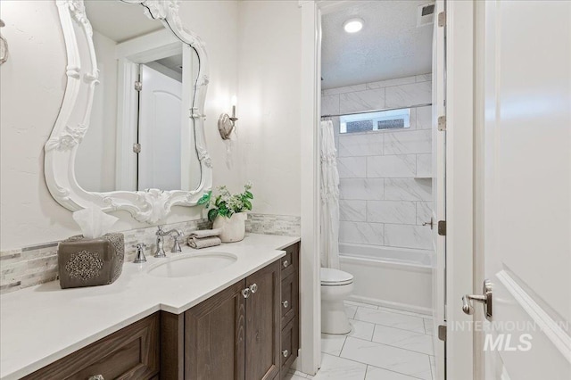 full bathroom featuring a textured ceiling, toilet, vanity, marble finish floor, and shower / bath combo