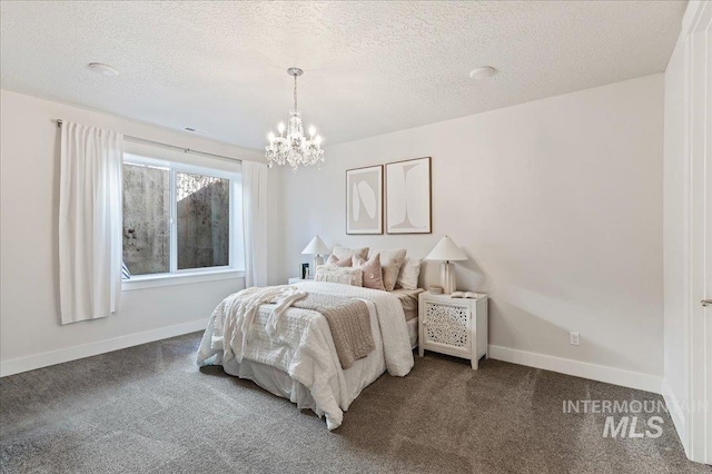 bedroom featuring carpet, baseboards, and a textured ceiling