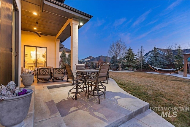 view of patio featuring outdoor dining area and a ceiling fan