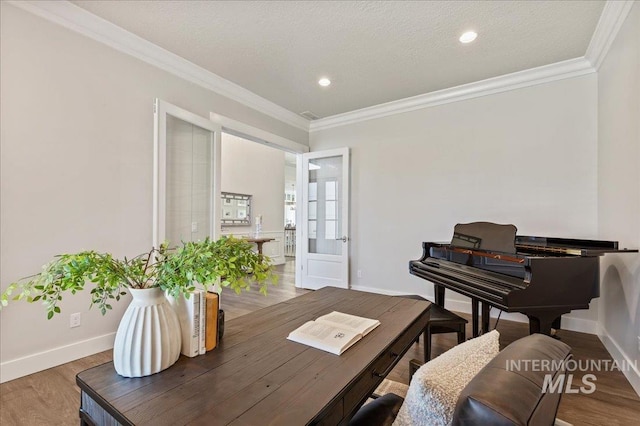 home office with baseboards, ornamental molding, and wood finished floors