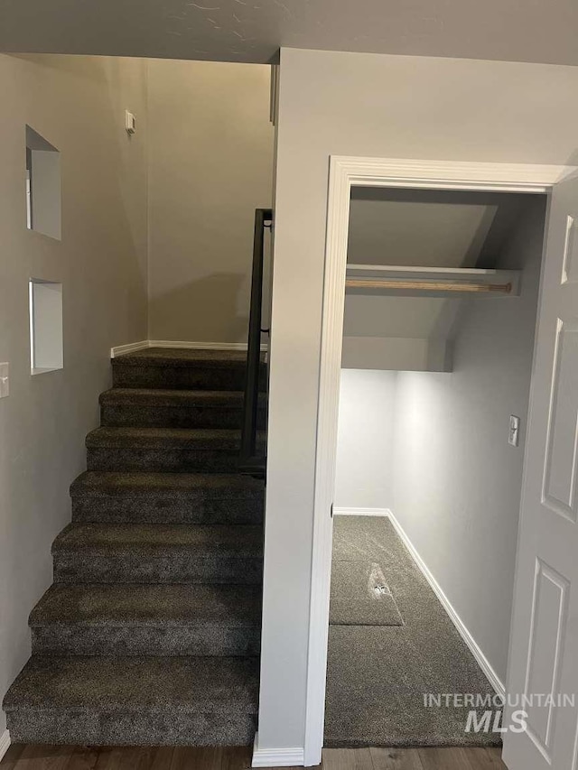 staircase with carpet and baseboards