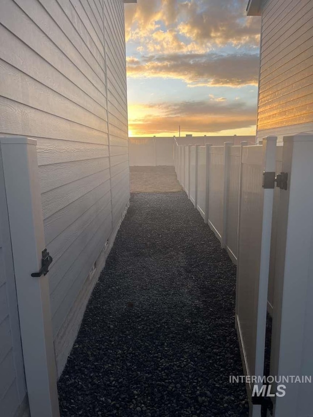 property exterior at dusk with a fenced backyard