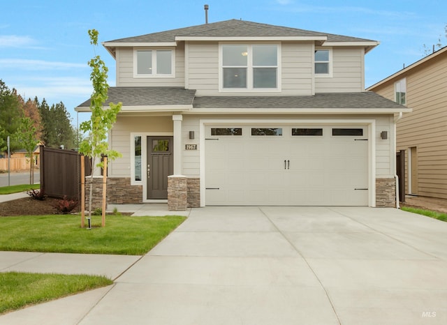 view of front of house featuring a garage and a front lawn