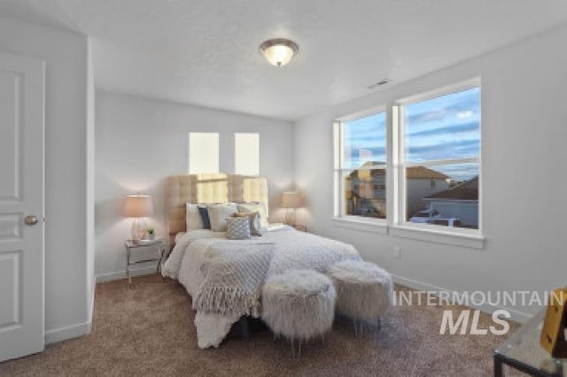 carpeted bedroom with vaulted ceiling