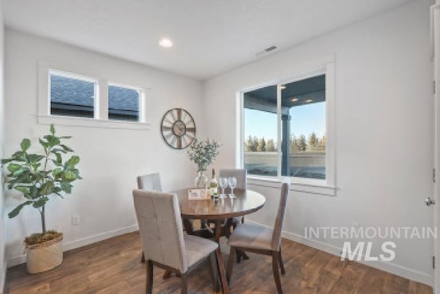 dining area featuring dark hardwood / wood-style floors