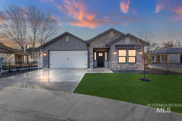 view of front of property with a garage and a lawn