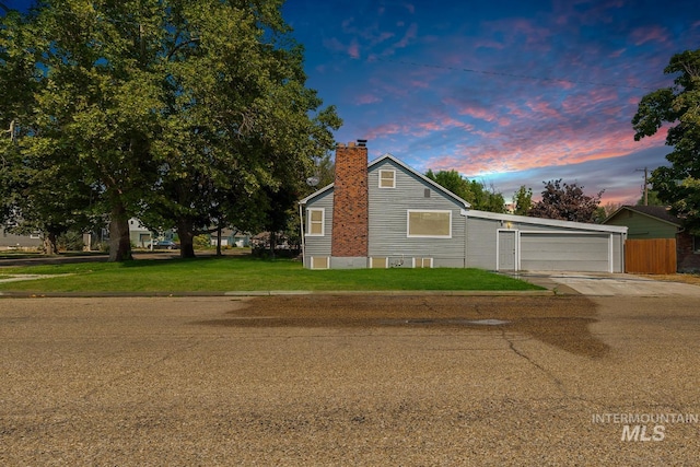 view of front of property featuring a garage and a yard