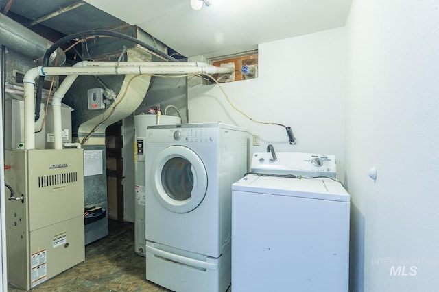 laundry area featuring independent washer and dryer and heating unit