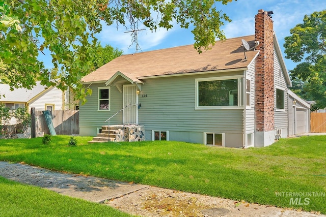 view of front of house featuring a garage and a front yard