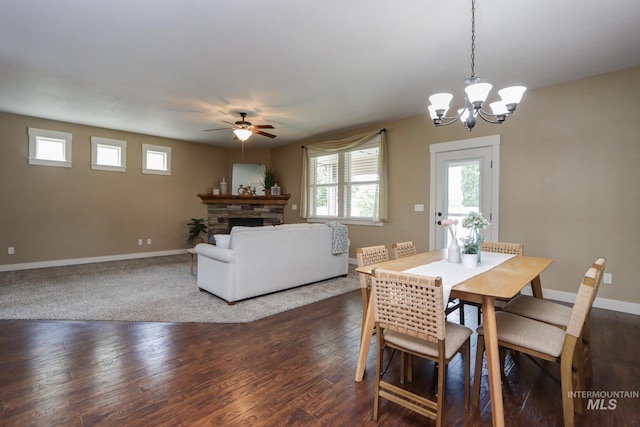 2018 S Sandcrest Loop, Nampa, ID 83686 - dining space featuring a chandelier, a ceiling fan, plenty of natural light, and a stone fireplace