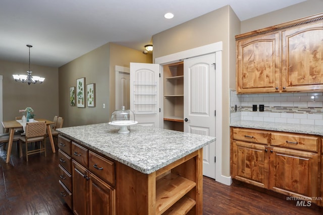 2018 S Sandcrest Loop, Nampa, ID 83686 - kitchen featuring dark wood finished floors, a chandelier, open shelves, backsplash, and pendant lighting