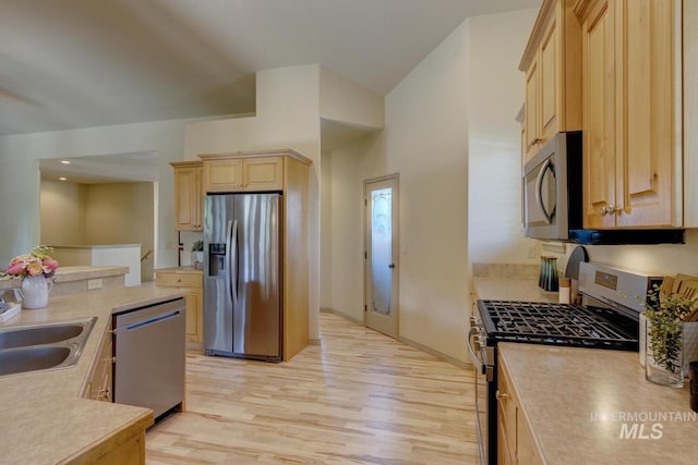 9407 W Pebblestream Dr, Boise, ID 83709 - kitchen with appliances with stainless steel finishes, light brown cabinetry, light countertops, and light wood finished floors