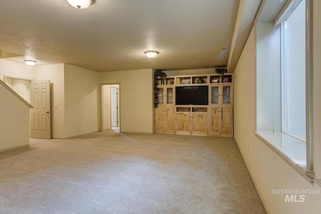9407 W Pebblestream Dr, Boise, ID 83709 - unfurnished living room featuring light carpet and a textured ceiling