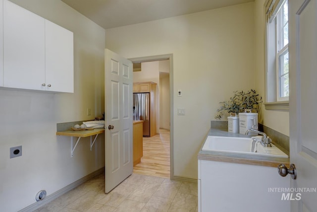 9407 W Pebblestream Dr, Boise, ID 83709 - laundry area featuring electric dryer hookup and cabinet space