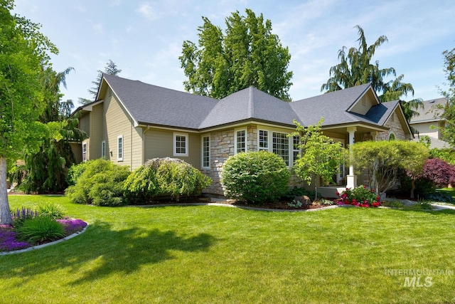 9407 W Pebblestream Dr, Boise, ID 83709 - view of front facade with a front lawn, stone siding, and a shingled roof