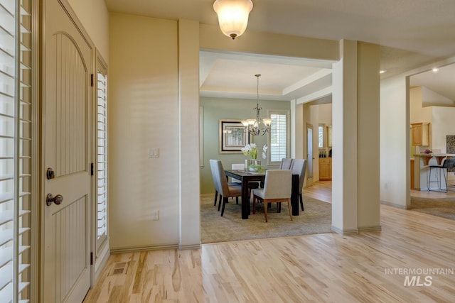 9407 W Pebblestream Dr, Boise, ID 83709 - foyer featuring light wood finished floors, a chandelier, and a raised ceiling
