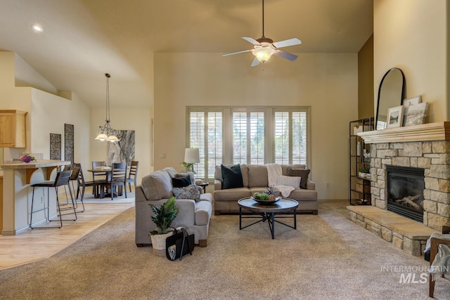 9407 W Pebblestream Dr, Boise, ID 83709 - living area featuring light carpet, high vaulted ceiling, ceiling fan, and a stone fireplace