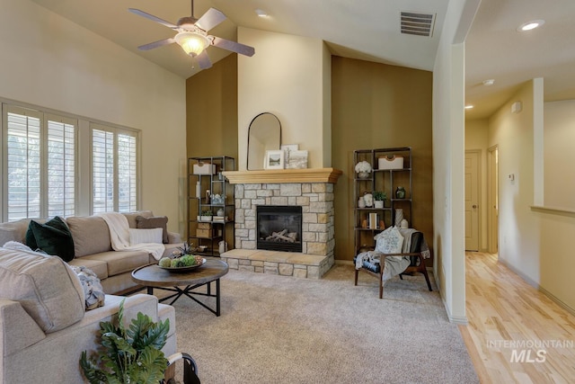 9407 W Pebblestream Dr, Boise, ID 83709 - living room featuring a ceiling fan, a fireplace, high vaulted ceiling, and light colored carpet