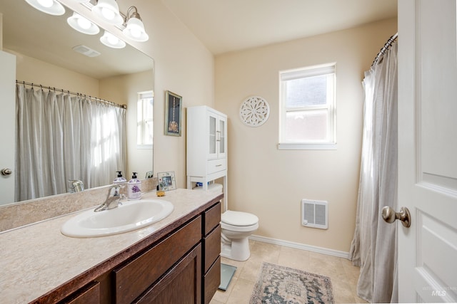 bathroom featuring toilet, vanity, tile patterned flooring, and visible vents