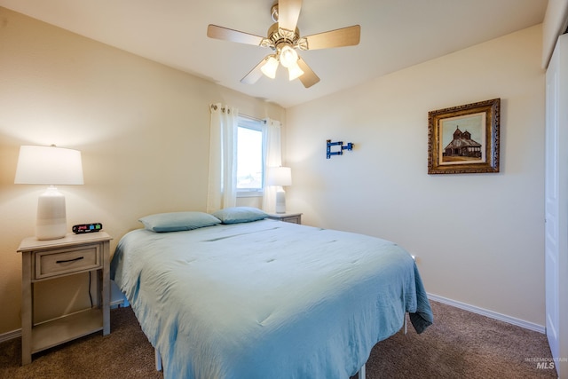 bedroom with a ceiling fan, dark colored carpet, and baseboards