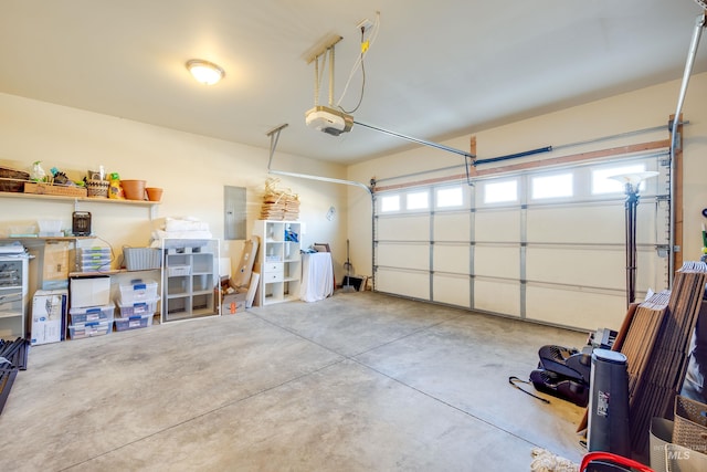 garage featuring electric panel and a garage door opener