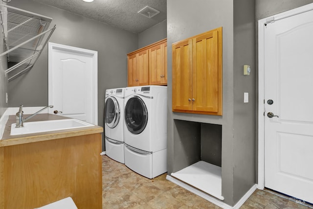 1390 E Prohaska Ct, Eagle, ID 83616 - washroom with washer and dryer, cabinet space, and a textured ceiling