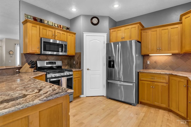 1390 E Prohaska Ct, Eagle, ID 83616 - kitchen featuring stainless steel appliances, light wood-style flooring, light stone countertops, decorative backsplash, and recessed lighting
