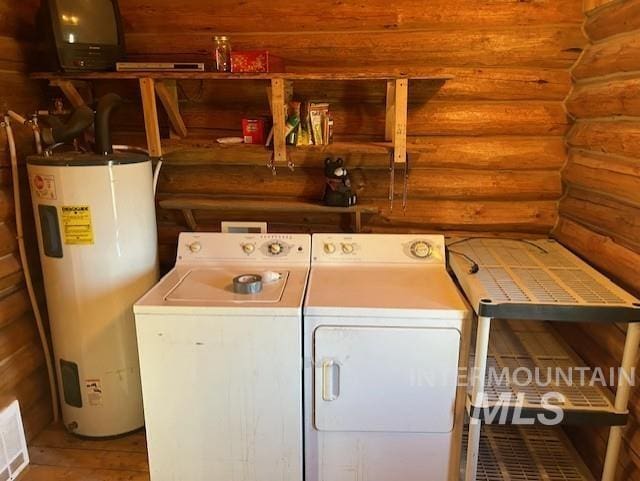 laundry area featuring water heater, log walls, and washer and dryer