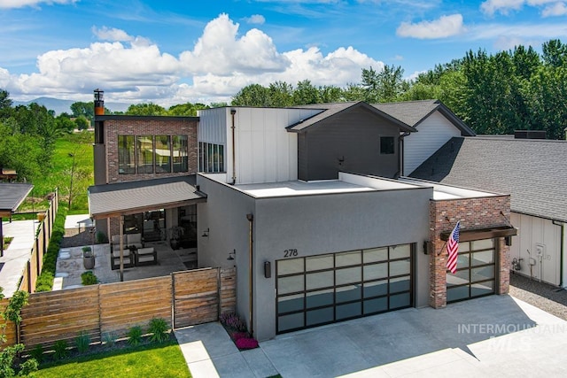 278 S Carbon Rivet Ave, Eagle, ID 83616 - contemporary house with a fenced front yard, an attached garage, concrete driveway, brick siding, and a gate