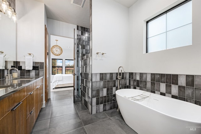 278 S Carbon Rivet Ave, Eagle, ID 83616 - ensuite bathroom with a freestanding bath, vanity, tile walls, and a wainscoted wall