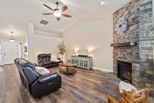 3499 S Green Basin Way, Nampa, ID 83686 - living room with vaulted ceiling, a ceiling fan, a stone fireplace, and wood finished floors