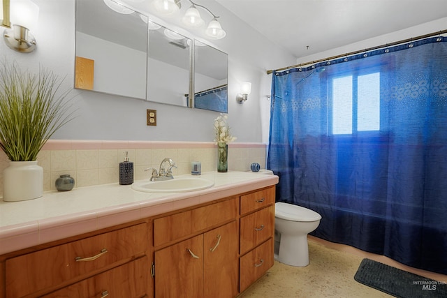 1520 R St, Heyburn, ID 83336 - full bathroom with toilet, vanity, speckle patterned floor, and a shower with shower curtain