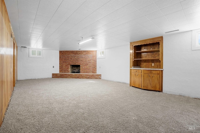 1520 R St, Heyburn, ID 83336 - unfurnished living room with a fireplace, carpet, and built in shelves