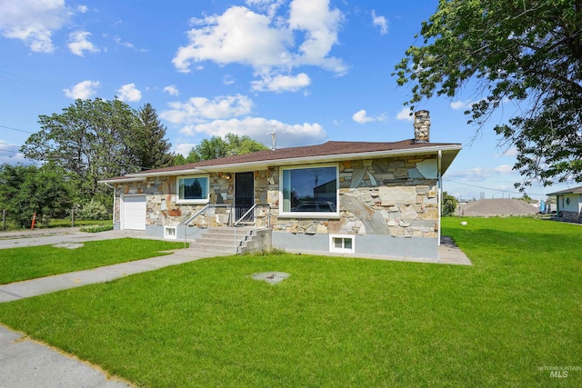1520 R St, Heyburn, ID 83336 - view of front facade featuring stone siding, a chimney, a front yard, and an attached garage
