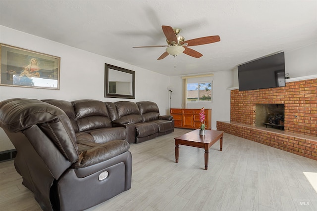 1520 R St, Heyburn, ID 83336 - living room with ceiling fan, light wood-type flooring, and a brick fireplace