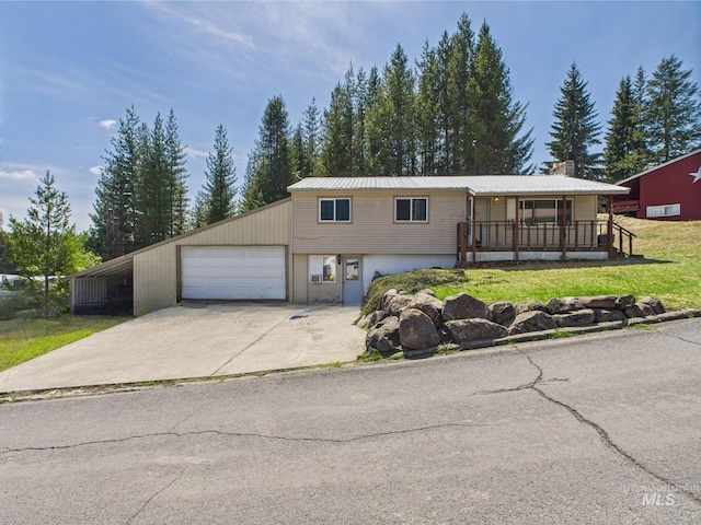 143 Timberline Dr, Pierce, ID 83546 - view of front of home featuring a porch, metal roof, a front yard, and a chimney