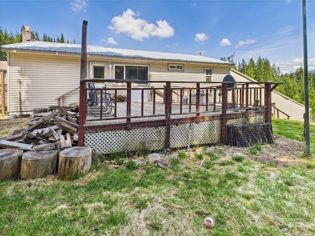 143 Timberline Dr, Pierce, ID 83546 - back of property featuring a wooden deck, metal roof, and a chimney