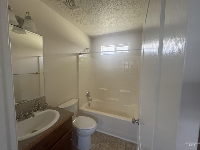 bathroom featuring a textured ceiling, toilet, visible vents, vanity, and shower / bathing tub combination