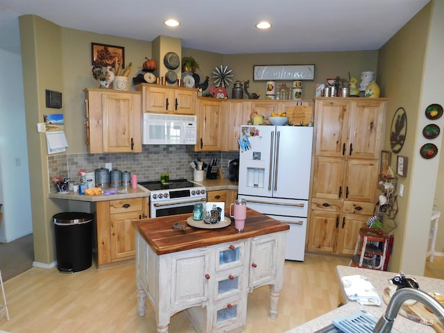 26737 Chips Ln, Parma, ID 83668 - kitchen with white appliances, light wood-style flooring, decorative backsplash, light brown cabinets, and recessed lighting