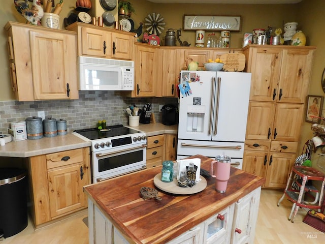 26737 Chips Ln, Parma, ID 83668 - kitchen with white appliances, tasteful backsplash, butcher block countertops, light brown cabinets, and light wood finished floors