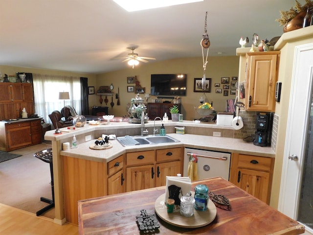 26737 Chips Ln, Parma, ID 83668 - kitchen with stainless steel dishwasher, light countertops, open floor plan, a ceiling fan, and a peninsula
