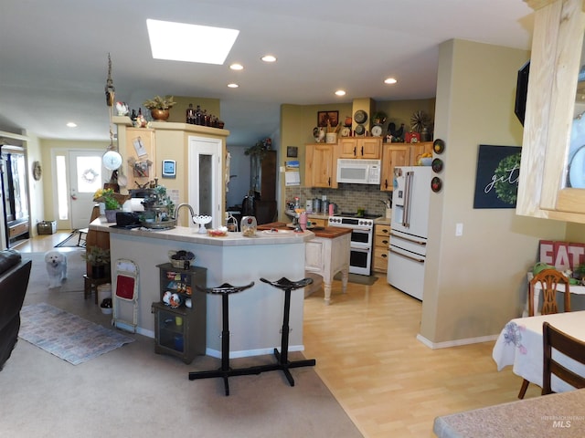 26737 Chips Ln, Parma, ID 83668 - kitchen with white appliances, a skylight, recessed lighting, tasteful backsplash, and light countertops