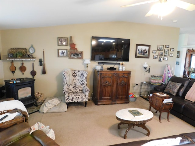 26737 Chips Ln, Parma, ID 83668 - living area with carpet, a wood stove, a ceiling fan, and vaulted ceiling